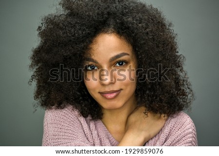 Close up horizontal portrait of beautiful young black woman on gray background. Royalty-Free Stock Photo #1929859076