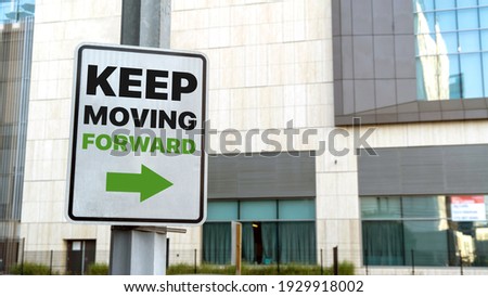 Keep moving forward sign in a downtown city setting