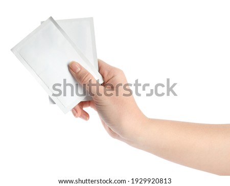 Woman holding medicine sachets on white background, closeup