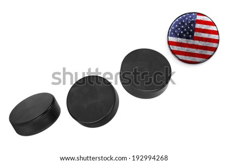 American hockey pucks lined up in a row on white background