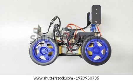 A programmable four-wheel drive robot car with obstacle avoidance and line tracking capability, Side view, Isolated picture