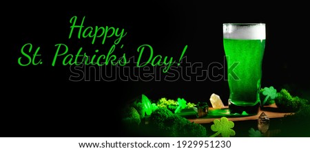 banner St. Patrick's Day Green Beer pint over wooden background, with shamrock leaves, harp. Patrick Day pub party, celebrating. Glass of Green beer close-up