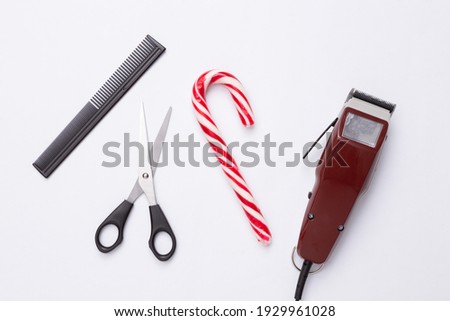 Machine for hairstyle (Hair clippers), scissors, comb and candy cane on white background. Barber symbol. Barbershop. 
