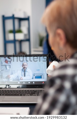 Old patient talking with doctor on virtual call showing pills bottle. Elderly woman on telemedicine online conference call with practitioner doctor using modern healthcare technology, web diagnosis