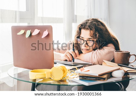 Bored woman studying at home. Student learning and working at home. Royalty-Free Stock Photo #1930001366