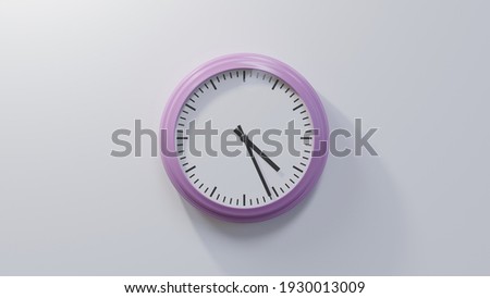 Glossy pink clock on a white wall at twenty-six past four. Time is 04:26 or 16:26 Royalty-Free Stock Photo #1930013009