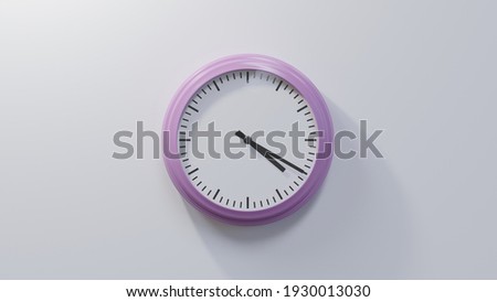 Glossy pink clock on a white wall at twenty past four. Time is 04:20 or 16:20 Royalty-Free Stock Photo #1930013030