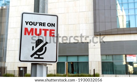You're on mute sign in a downtown city setting Royalty-Free Stock Photo #1930032056