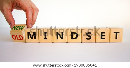 New vs old mindset symbol. Businessman turns the wooden cube and changes words 'old mindset' to 'new mindset'. Beautiful white background. Business, new or old mindset concept. Copy space.