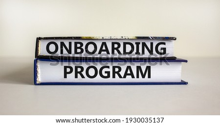 Onboarding program symbol. Books with words 'onboarding program' on beautiful white background. Business and onboarding program concept. Copy space.
