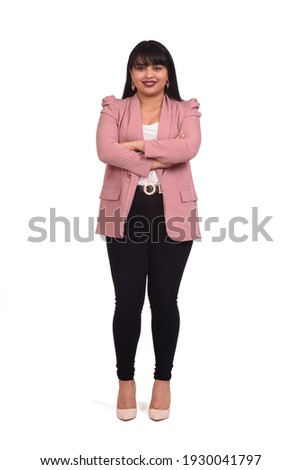 front view of latin woman with pants, blazer and high heels on white background, arms crossed