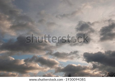 cloudy sky with rare dark gray clouds with threat of rain Royalty-Free Stock Photo #1930094381