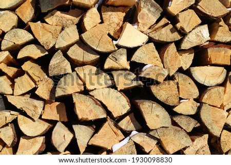 Full Frame Pile of Firewood Background Weathered Cracked Wood Texture 