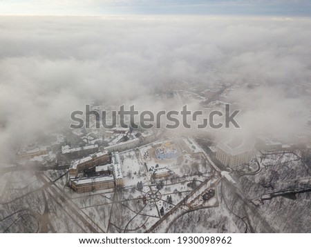 Fog over the snow-covered St. Michael's Cathedral in Kiev. Aerial drone view. Foggy winter day.