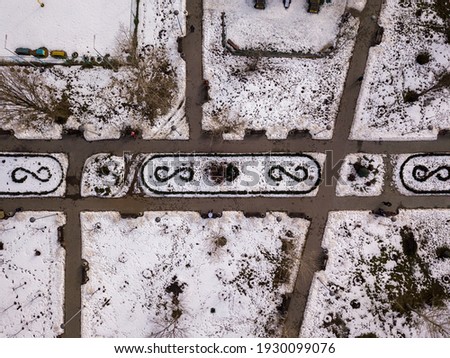 Snowy park. Aerial drone top view. Cloudy winter day.