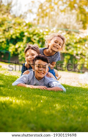 Portrait of three little children as a tower Royalty-Free Stock Photo #1930119698