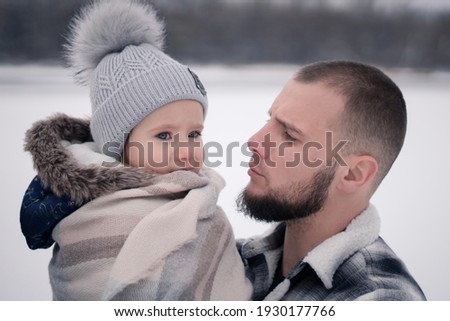 Portrait of father and daughter in the snow
