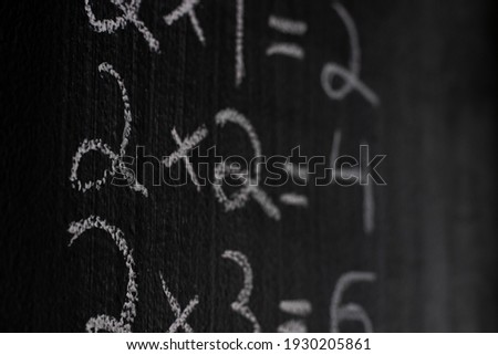 A close up of math equations on a blackboard.