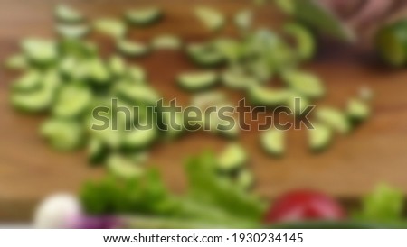 Defocused people cooking delicious food in kitchen. Preparing vegetable for healthy food.
