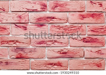 Seamless background pattern of vivid red decorative bricks on the wall surface. Interior design and materials