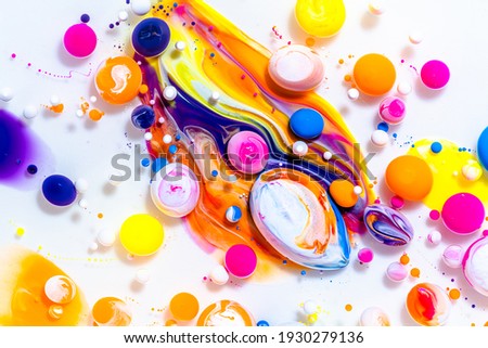 Fluid art texture. Abstract background with iridescent paint effect. Liquid acrylic picture with flowing bubbles. Mixed paints for posters or wallpapers. Rainbow overflowing colors.