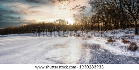 Winter landscape with snow and a frozen lake in the Netherlands