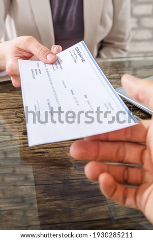 Hand Holding Money Cheque Or Payroll Check