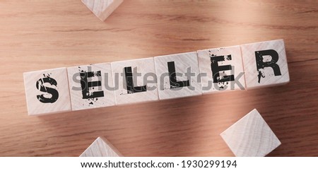 Seller, word cube with background. Business concept.