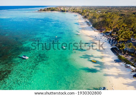 Aerial photography of the East coast of the island of Mauritius. Flying over the turquoise lagoon of Mauritius in the Belle Mare area.Coral reef of Mauritius. Mauritius Island Beach. Royalty-Free Stock Photo #1930302800