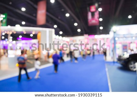 Abstract blur people in exhibition hall event trade show expo background. Large international exhibition, convention center, business marketing and event fair organizer concept. Royalty-Free Stock Photo #1930339115