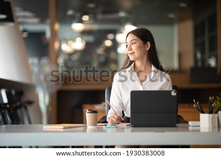 Shot of a asian young business Female working on laptop in her workstation.