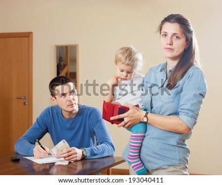 Family of three with baby having  financial problems at home Royalty-Free Stock Photo #193040411