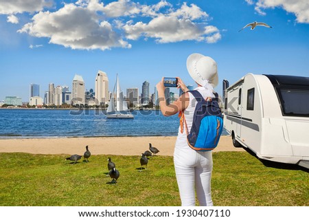 Panoramic View Of Downtown San Diego with caravan or towed trailer on seaside background. Caravan car Vacation. Coastal landscape from Coronado Island California