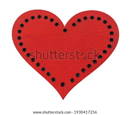 Wooden red painted heart with circle cavities isolated on white background. 