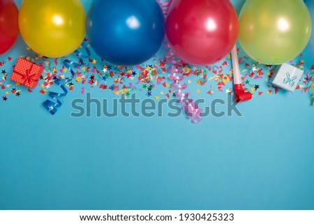 Flat party decoration concept on pastel blue background from above