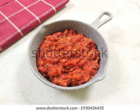 Hot and spicy chili sauce known as sambal in Indonesia. Sambal very popular and the most favorite dish amongst Indonesian people. Served on white background. 