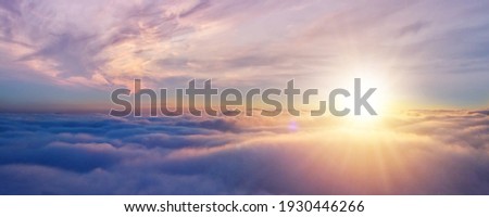 Beautiful sunset cloudy sky from aerial view. Airplane view above clouds Royalty-Free Stock Photo #1930446266