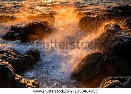 Sunrise view of waves on sea rocks of Igidae Park at Busan, South Korea 

