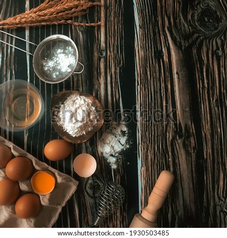 Culinary preparation with egg flour on the wooden texture flat lay