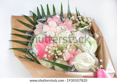 Gingerbread and marshmallows in the form of a bouquet of flowers on a light background. Concept of Spring Woman Day Holiday, Mothers Day background.