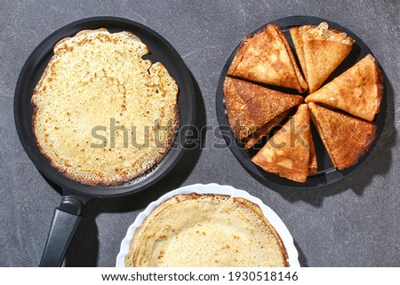 Thin pancakes from Russian cuisine. Russian blini, crepes on a gray background. Shrovetide holiday. Pancake week. Top view.