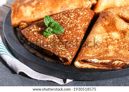 Thin pancakes from Russian cuisine. Russian blini, crepes on a gray background. Shrovetide holiday.