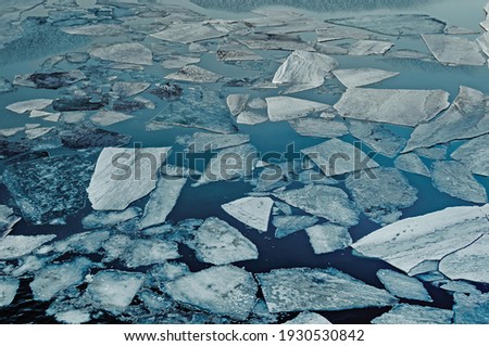 Natural ice blocks in water. Sea ice during freezing winter weather.
