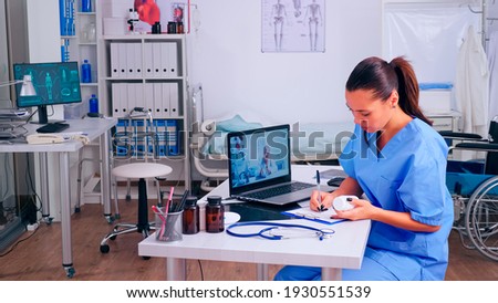 Assistant taking notes listening advice of remote doctor during video call, virtual health conference, training webinar concept. Medical physician talking diagnoses patients, online meeting Royalty-Free Stock Photo #1930551539