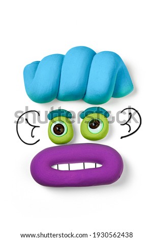 Animated face by soft clay isolated on the white background. Cartoon plasticine face with drawn elements