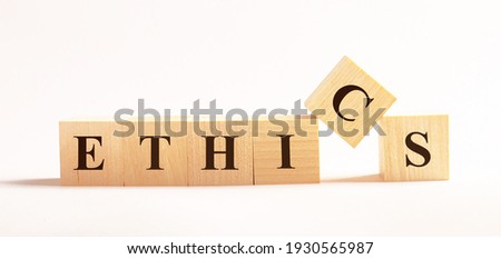 On a light background, wooden cubes with the text ETHICS