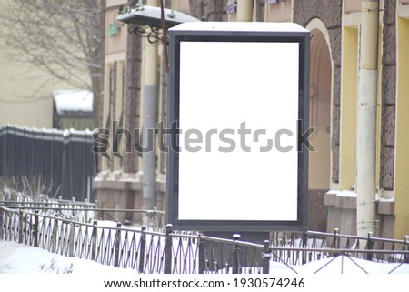 Advertising billboard in the city in winter.