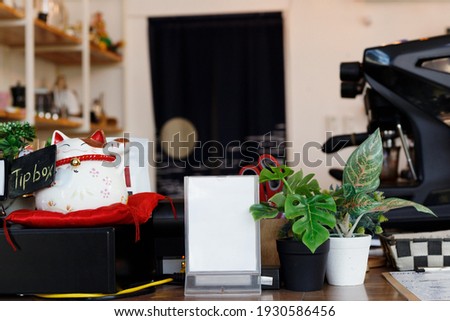 blank white frame standing on counter in bar cafe coffee maker background, Mockup