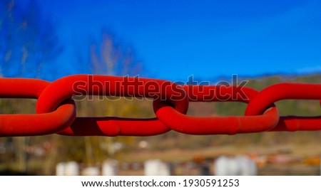 Red iron chain close up outdoors