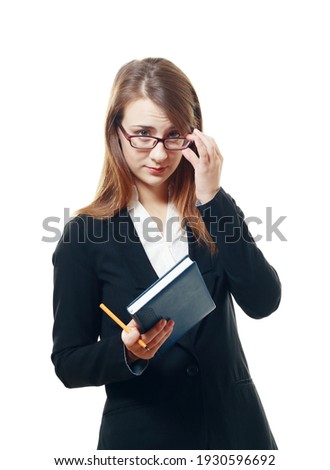 suspecious woman manager hold notebook and looking over glasses
